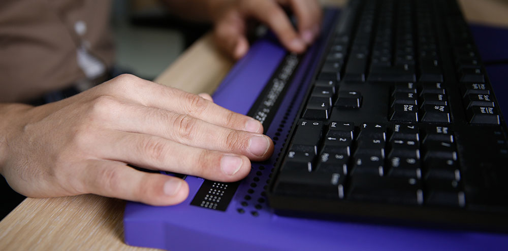 accessibility-page Hands of a person using an accessible keyboard
